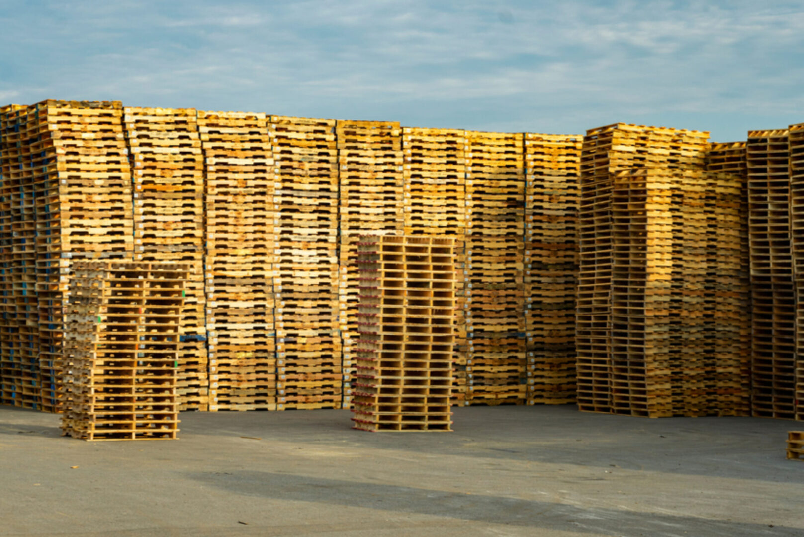 A pile of wooden pallets stacked on top of each other.